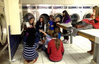 University of Arkansas childhood education students read to children at a Rogers laundromat last year.