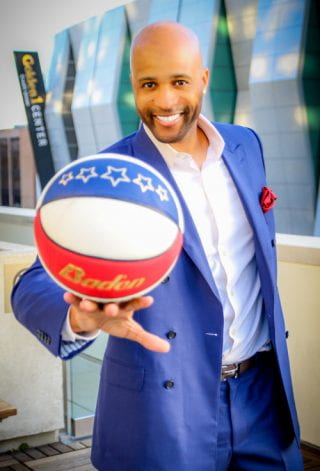 The U of A campus community and the Best-selling author, speaker, The Amazing Race competitor and former Harlem Globetrotter Herbert "Flight Time" Lang holding basketball.