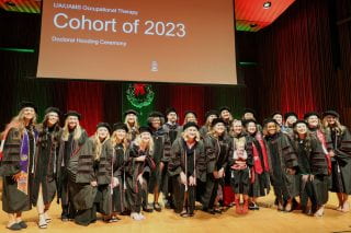 Occupational Therapy doctoral students in the 2023 cohort pose for a photo after the hooding ceremony held prior to commencement.